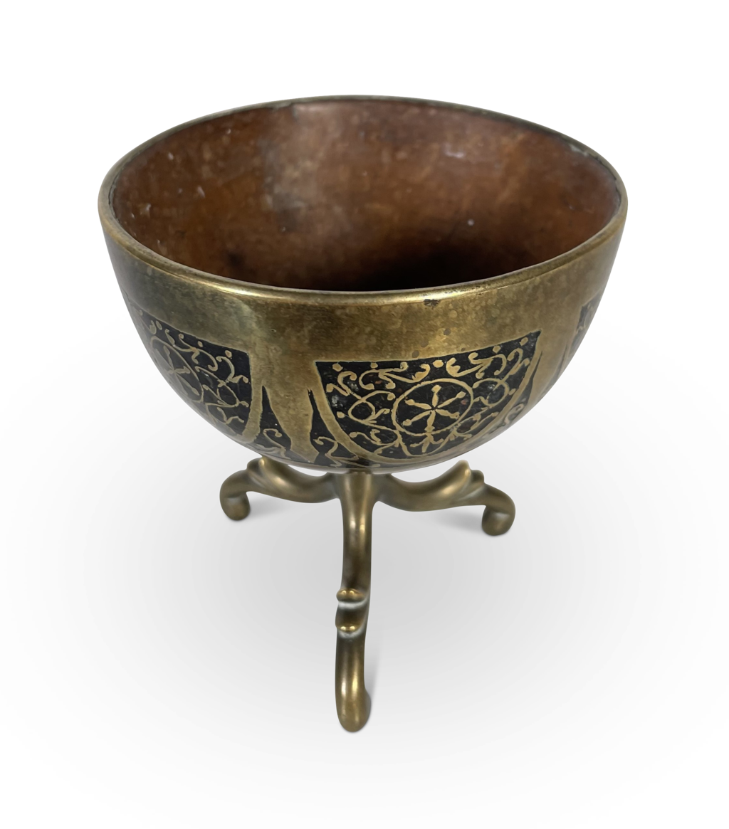 Coconut Cup in a Pierced Brass Decorated Case Elevated on a Tripod Base
