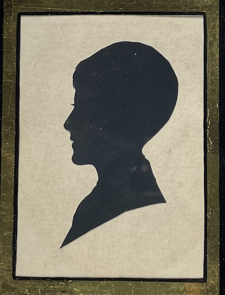 Silhouette Portrait of a Boy Mounted behind Glass in a Square Ebonsied Frame