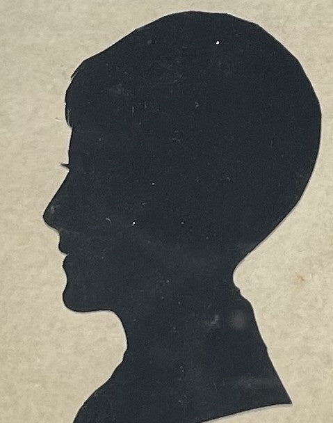 Silhouette Portrait of a Boy Mounted behind Glass in a Square Ebonsied Frame