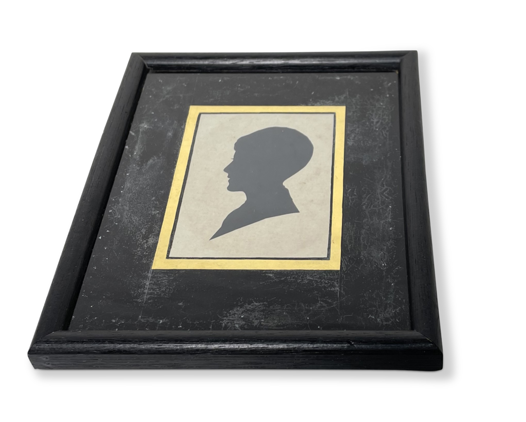 Silhouette Portrait of a Boy Mounted behind Glass in a Square Ebonsied Frame